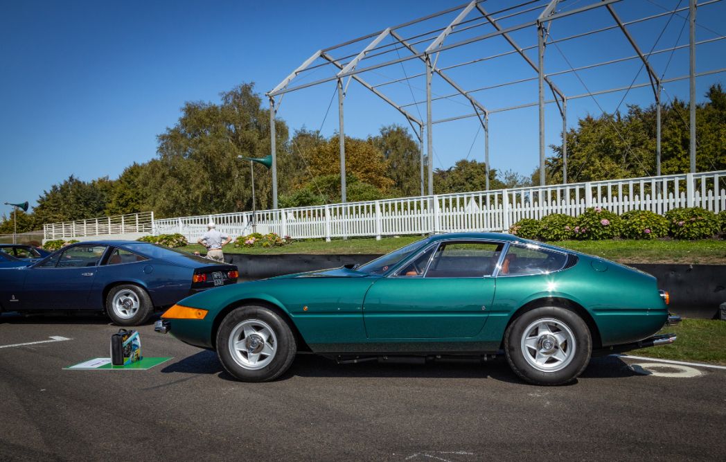 Classic green Ferrari 365 GTB/4 Daytona coupe with perspex covered headlights and silver five-spoke wheels.