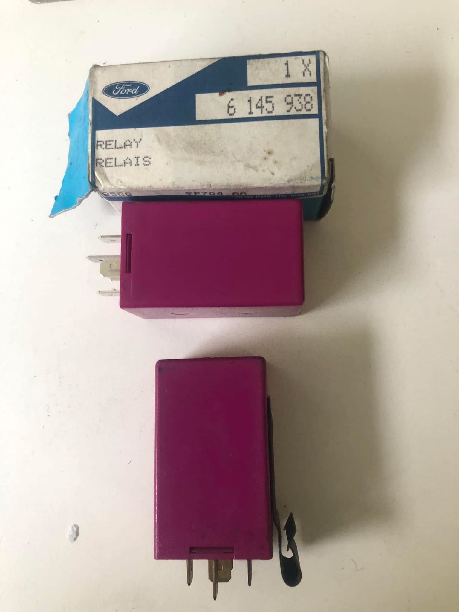 A new Ford fuel pump relay (part number 6 145 938) for a classic Escort RS Turbo in its original box, shown next to an identical used relay.