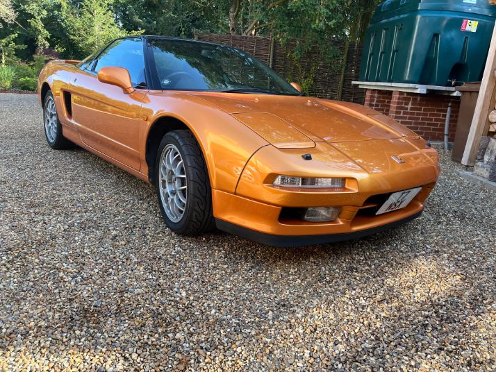 orange Honda NSX sports car on gravel driveway aftermarket wheels classic JDM legend