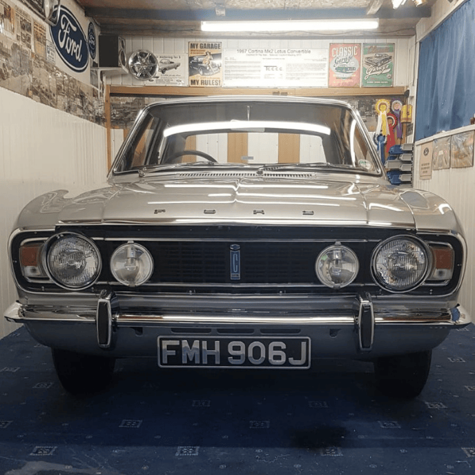 Silver Mark 2 Ford Cortina classic saloon with bright chrome bumper and grill.