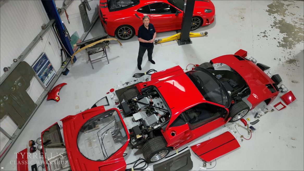 Red Ferrari F40 restoration engine bay overhead view stripped down supercar workshop