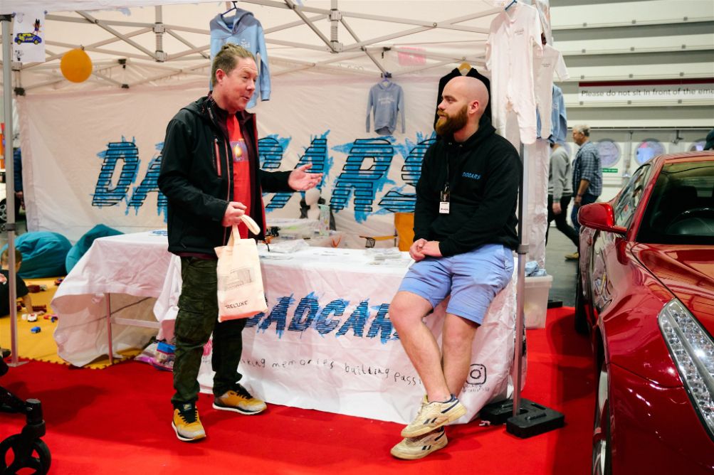 DadCars YouTuber discussing Ferrari's and family friendly automobiles like Land Rover in the DadsCars Family Zone at the Classic Motor Show in Nc, Birmingham 7-9 November 2025