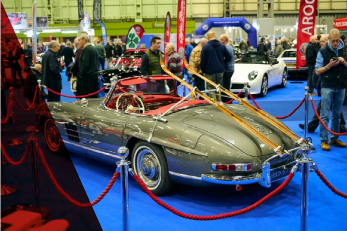 Grey Mercedes-Benz 300 SL Roadster with skis on rack at the Classic Motor Show, showcasing rare vintage sports cars