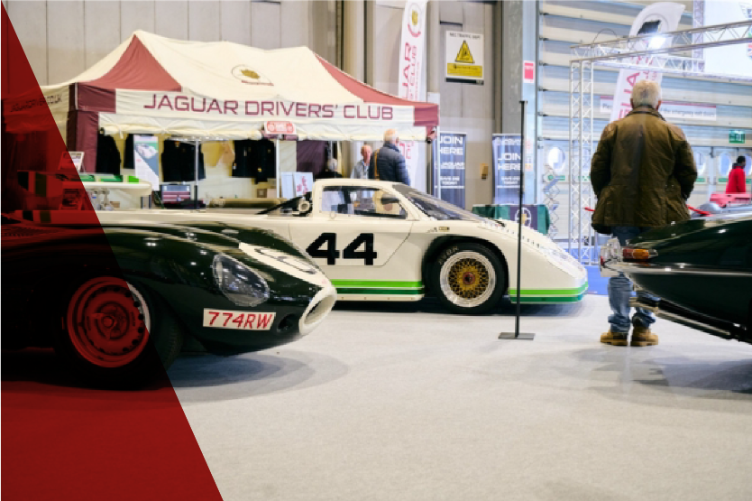 Rare Jaguar D-Type and modern classic Jaguar race cars displayed at the Jaguar Drivers' Club stand during the Classic Motor Show.