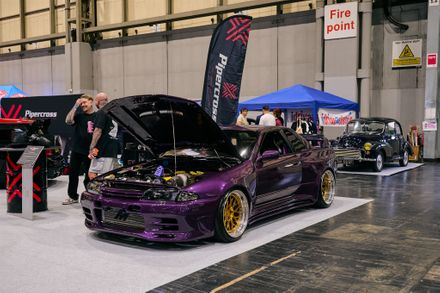 A modified car display inside an exhibition hall at the Classic Motor Show