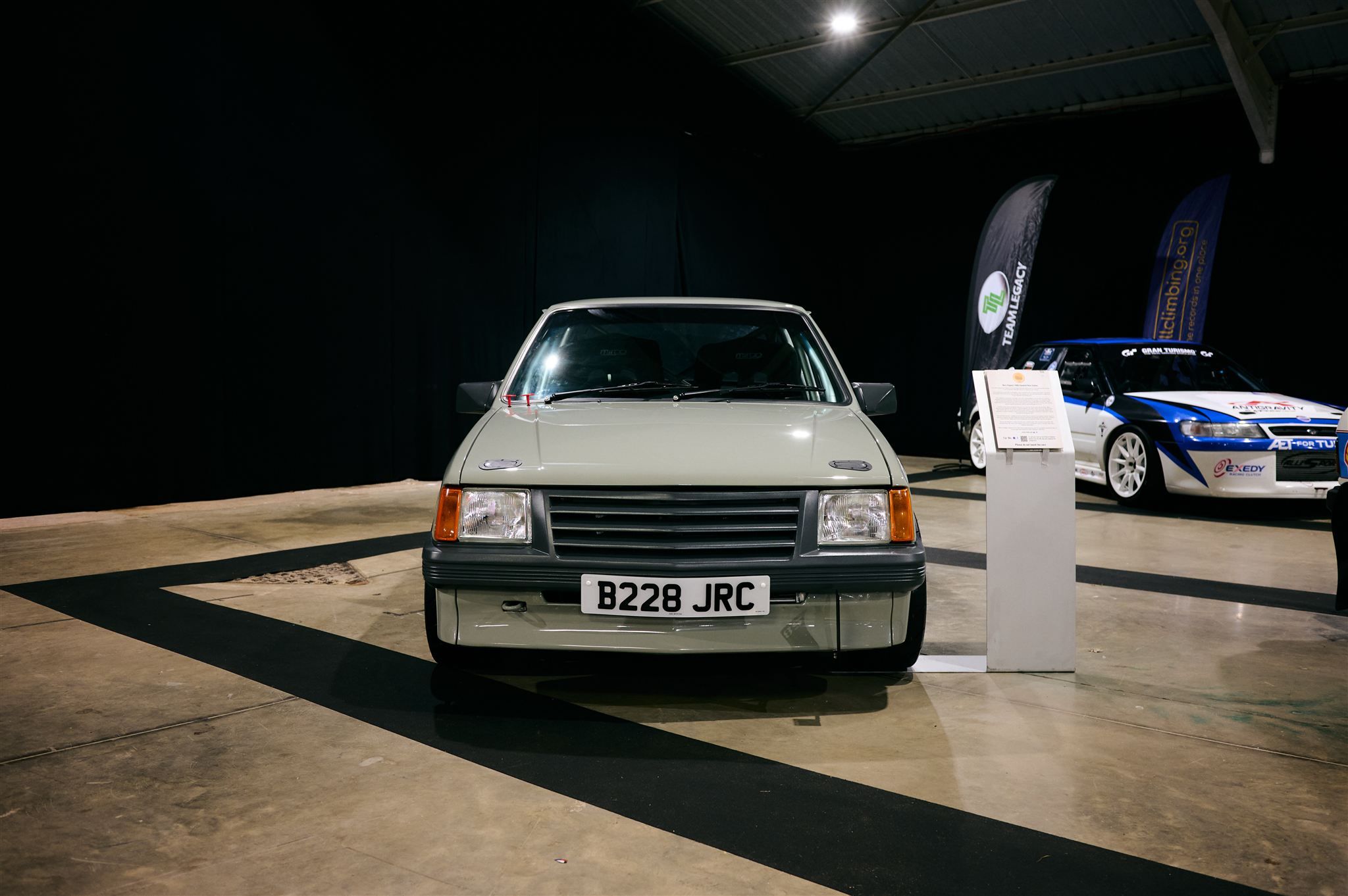 Front view of a custom grey Vauxhall Nova B228 JRC at a Pride of the Paddock exhibition.
