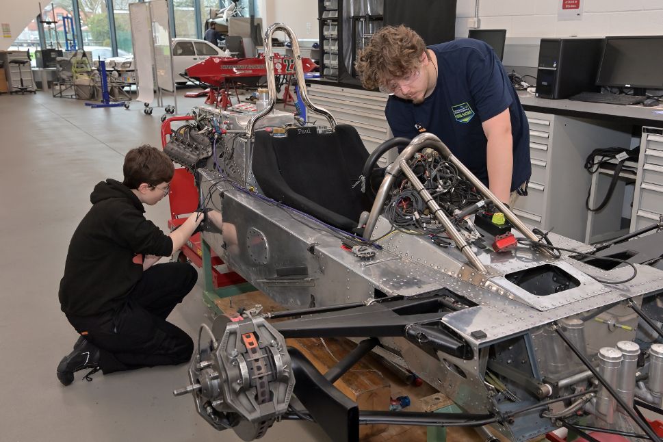 Engineering students at the National Centre for Motorsport Engineering (NCME) at the University of Bolton working on the chassis of a historic 1981 Ensign N180B Formula 1 car.