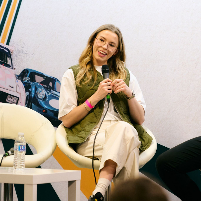 Hollie McRae, daughter of legend Colin McRae, speaking on stage at a motorsport heritage event.