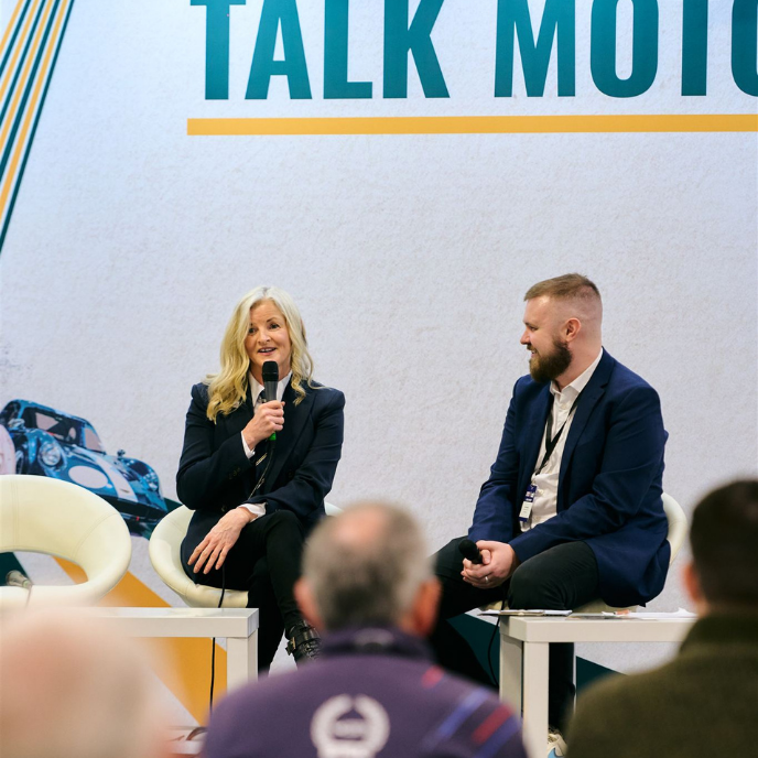 Professional motorcycle racer Maria Costello speaking on stage during a Talk Motorsport interview.