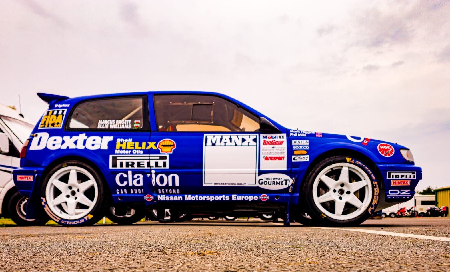 Blue Nissan Sunny F2 rally car with Dexter and Shell Helix livery, showcasing the competition build for driver Marcus Padgett.