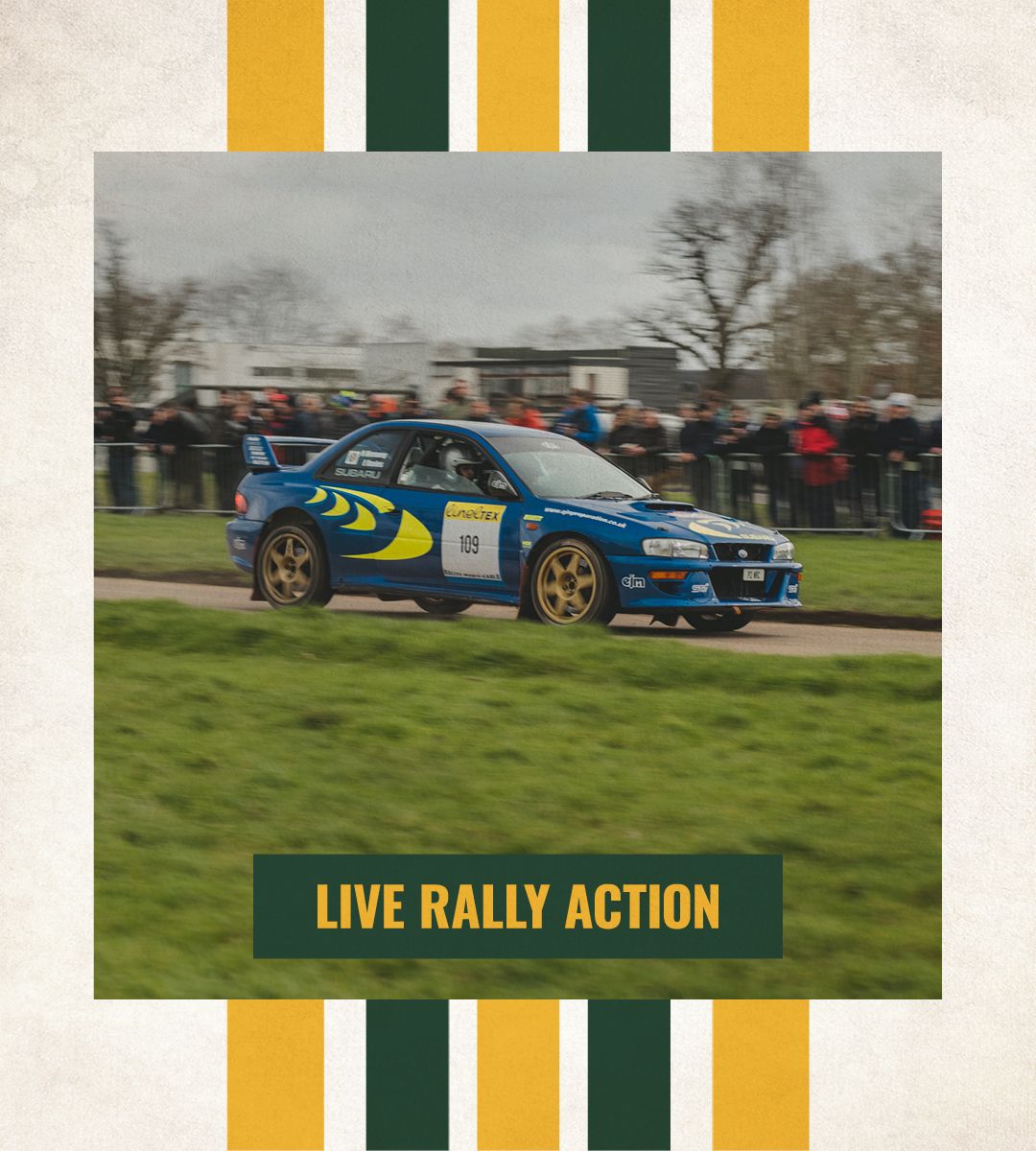 Blue Subaru Impreza rally car driving at speed during a live rally action demonstration at a motorsport show.