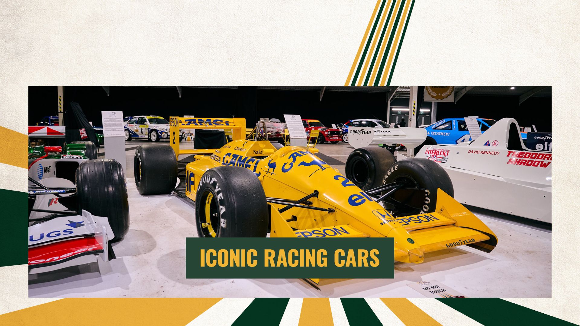 A classic yellow Camel-sponsored Lotus Formula 1 car on display at a historic racing car exhibition.