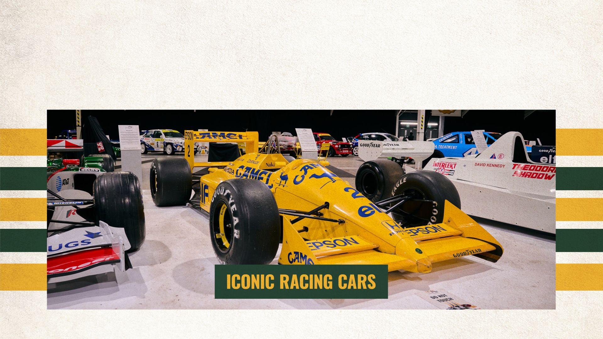 A classic yellow Camel-sponsored Lotus Formula 1 car on display at a historic racing car exhibition.