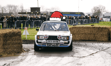 Talbot Sunbeam Lotus Group 2 rally car black silver Christmas setting snow wheels.