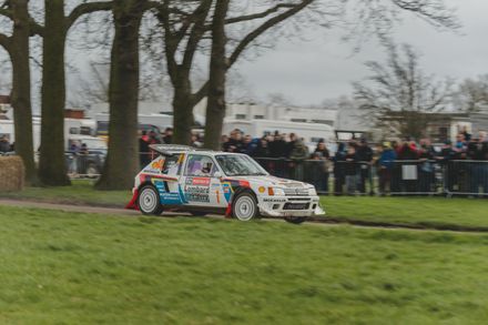 Peugeot 205 T16 Group B rally car driving at Race Retro exhibition.