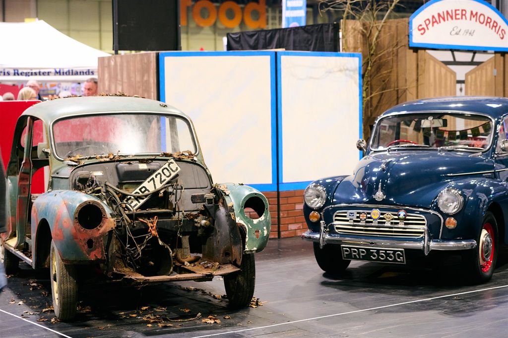 A side-by-side restoration comparison of a classic Morris Minor shell (ERB 720C) next to a fully restored dark blue Morris Minor 1000 (PRP 353G) at a car show.
