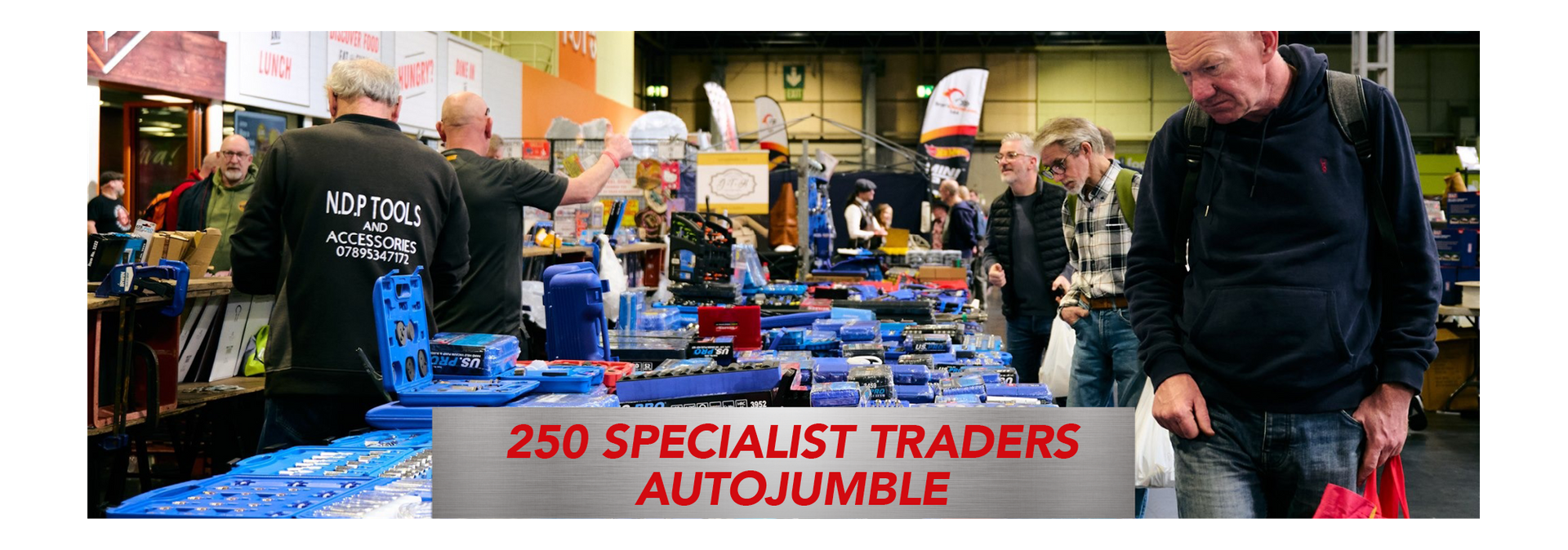 Crowded autojumble and tool market at a classic car show with 250 specialist traders selling automotive parts and accessories.