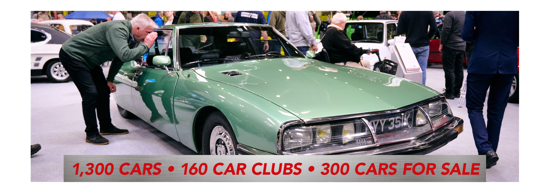 A mint condition green Citroen SM on display at a classic car show featuring 1,300 cars, 160 car clubs, and 300 cars for sale.