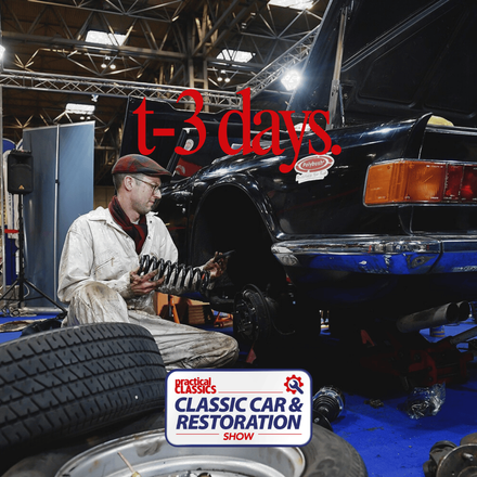 Mechanic restoring a vintage car suspension at the Practical Classics Classic Car & Restoration Show with a 