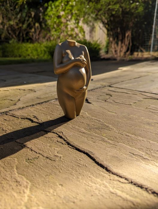 Gold pregnancy sculpture