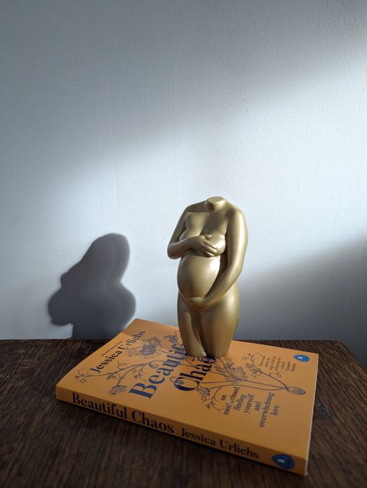 Gold pregnancy sculpture