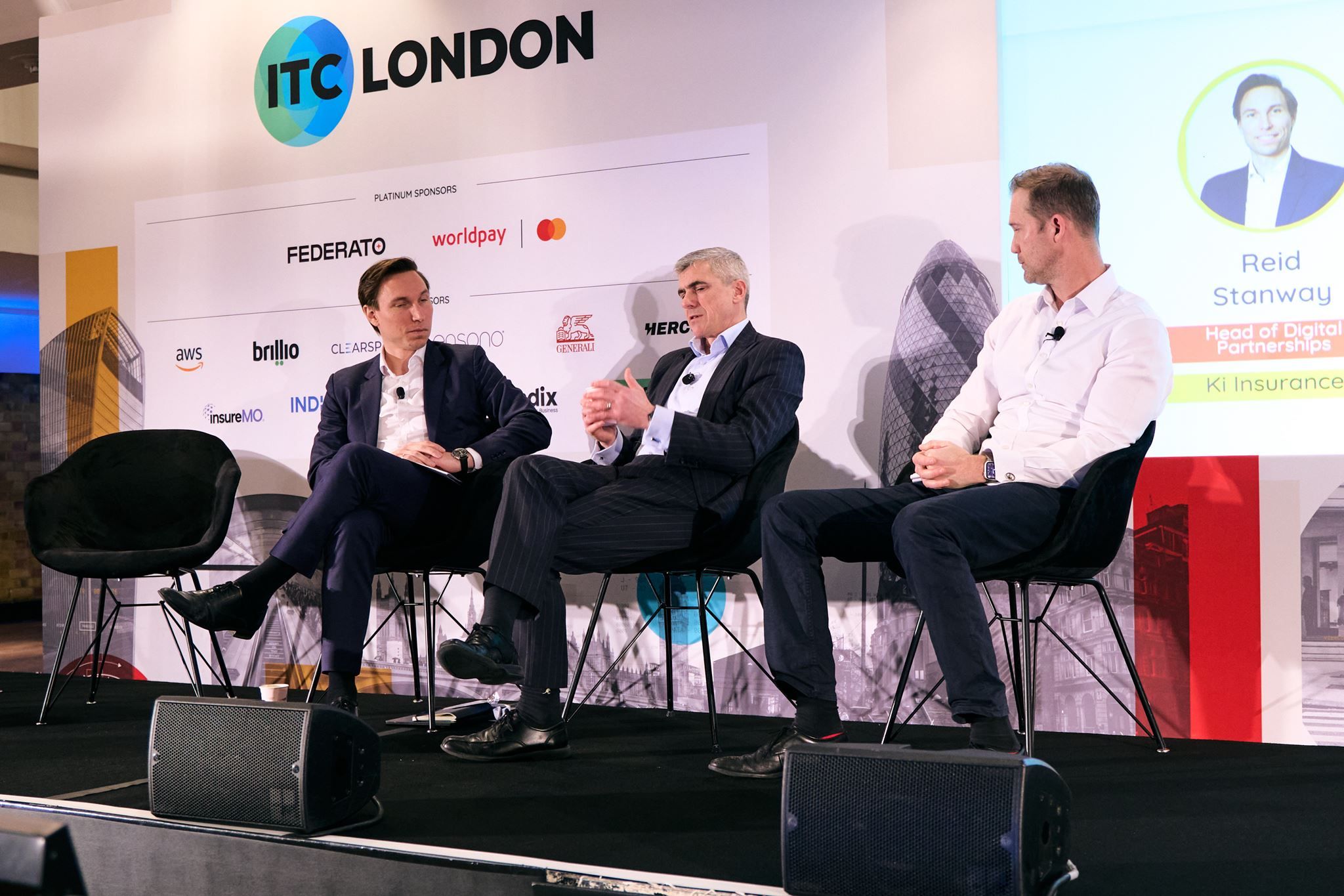 Reid Stanway of Ki moderating a panel with Dan Walsh and Trent Sommerville of Ardonagh Specialty on the Main stage at ITC London 2026
