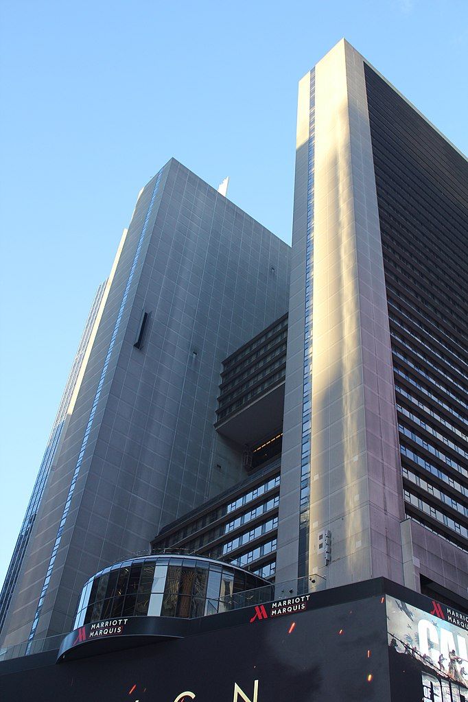 An upward angled shot of the New York Marriott Marquis hotel