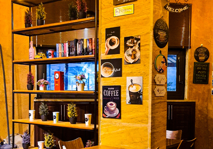 Coffee books and other retail items on a bookcase in a coffee shop