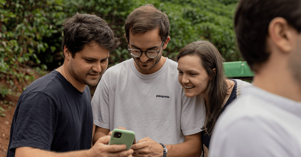 Ocafi team looking at a phone