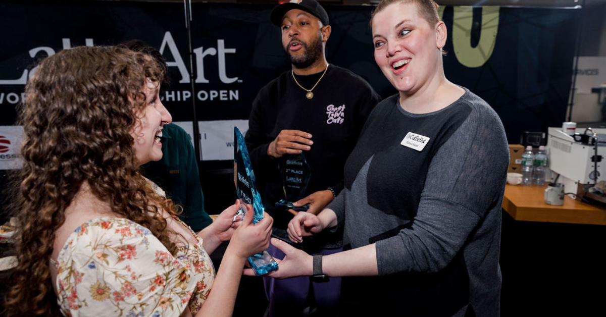 Terika Raak (Head Judge) handing 1st place winner trophy while Antoine Franklin (Judge) looks on