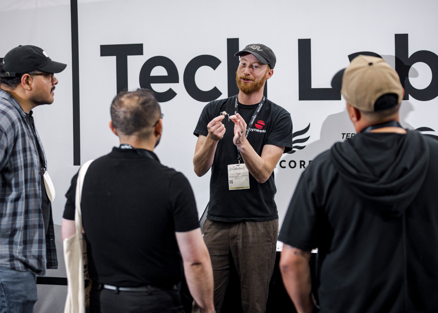 Instructor holding piece of tech and explaining to group