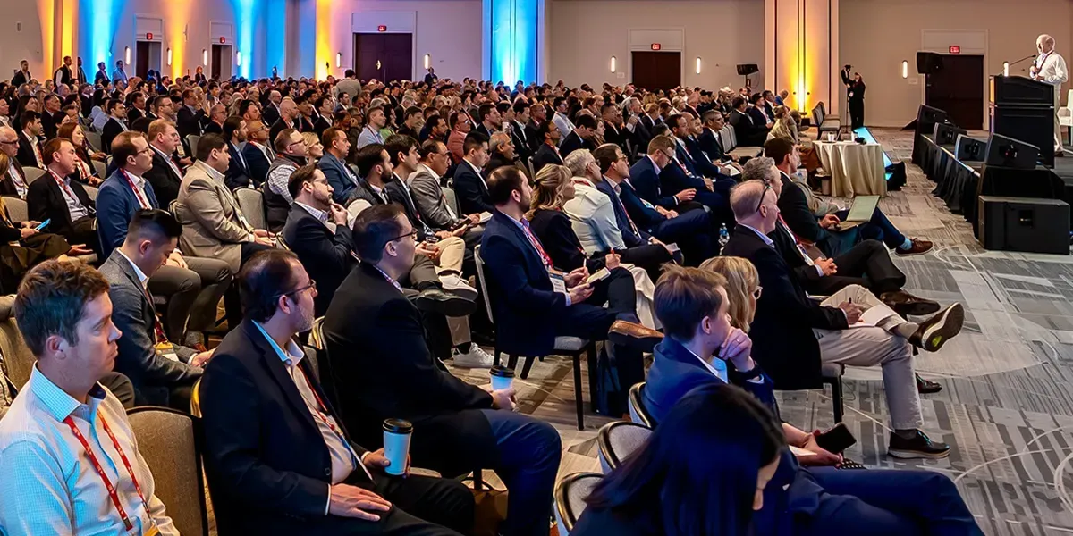 A paked room of attentive audience members