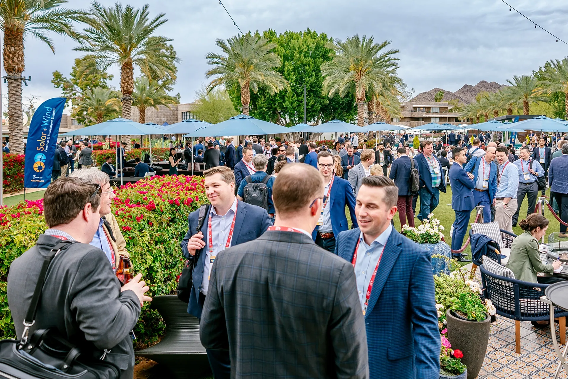 Business professionals gathered outdoors around the Spire Bar, networking and chatting