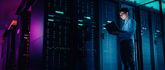 An engineer working in front of server racks at a data center