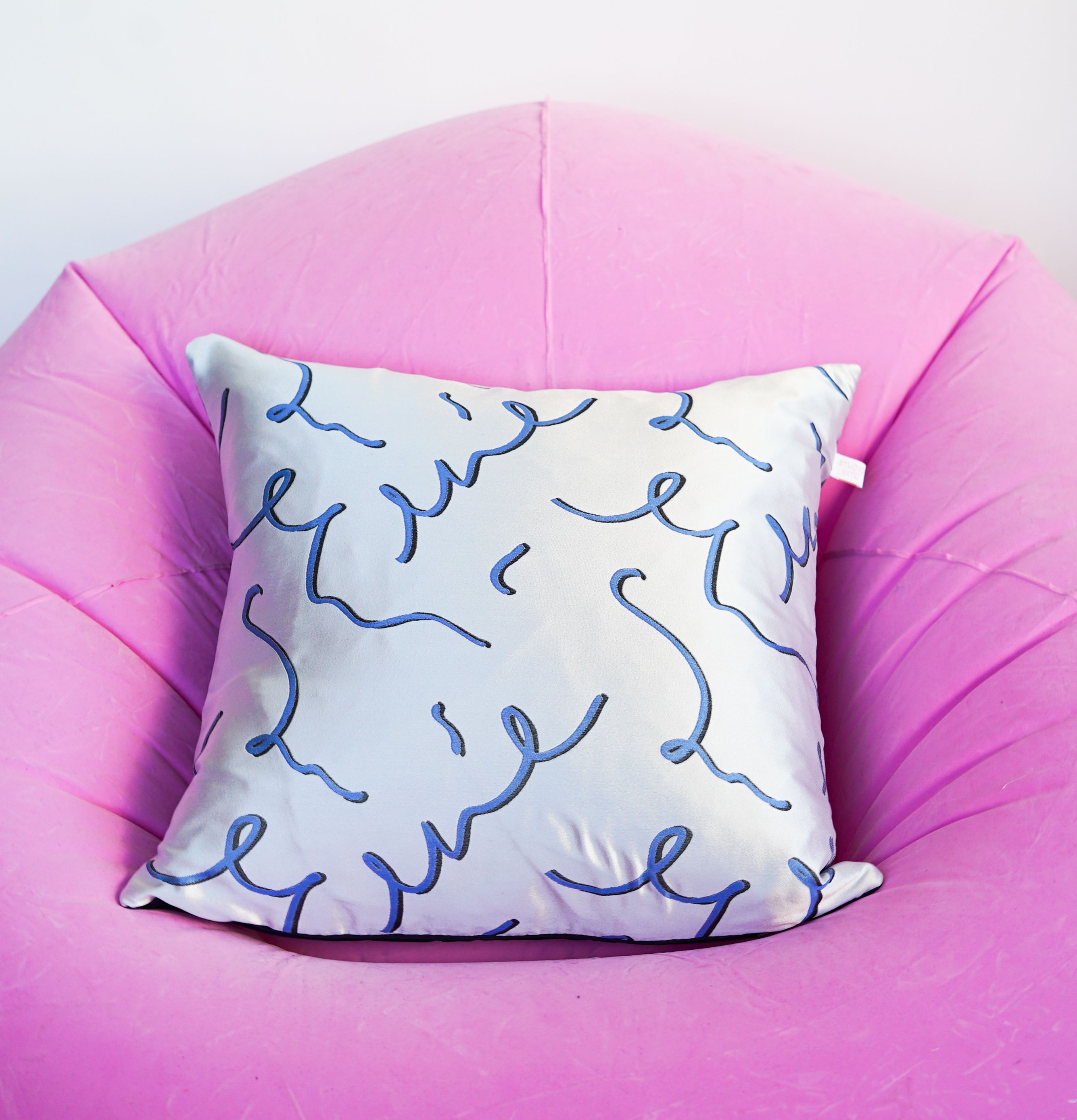 cushion on pink chair