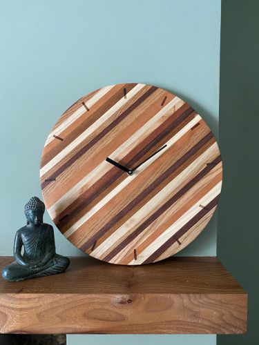 large circular striped mixed wood wall clock