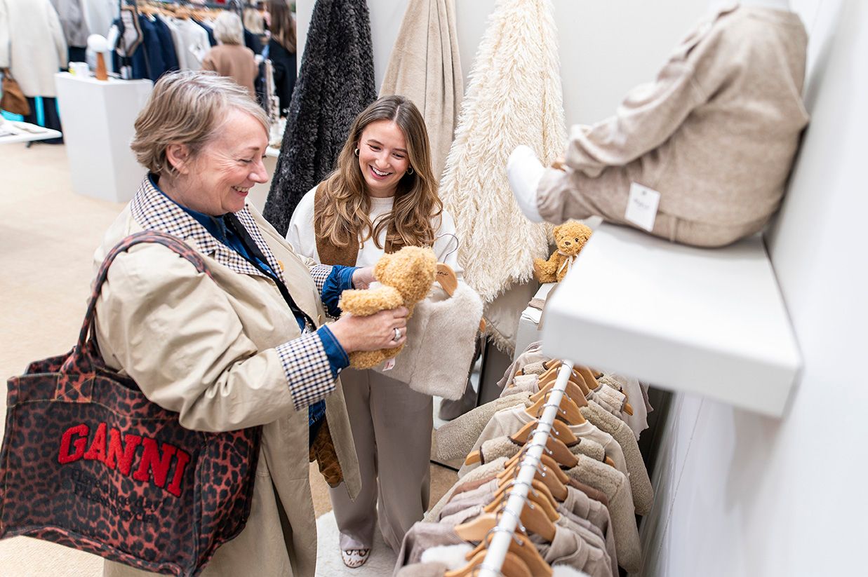 Engaged buyers smiling down at a teddy