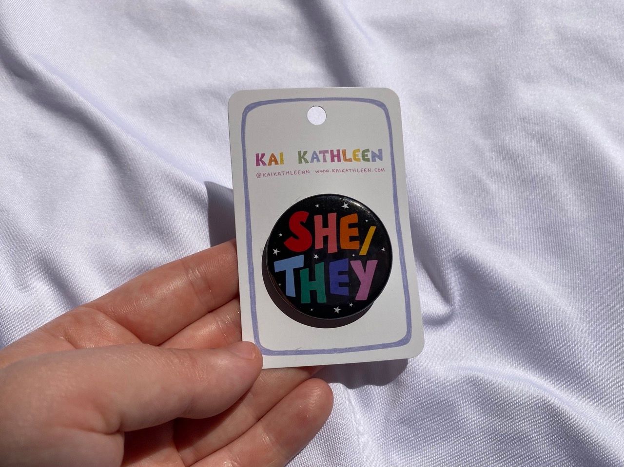She/they pronoun badge