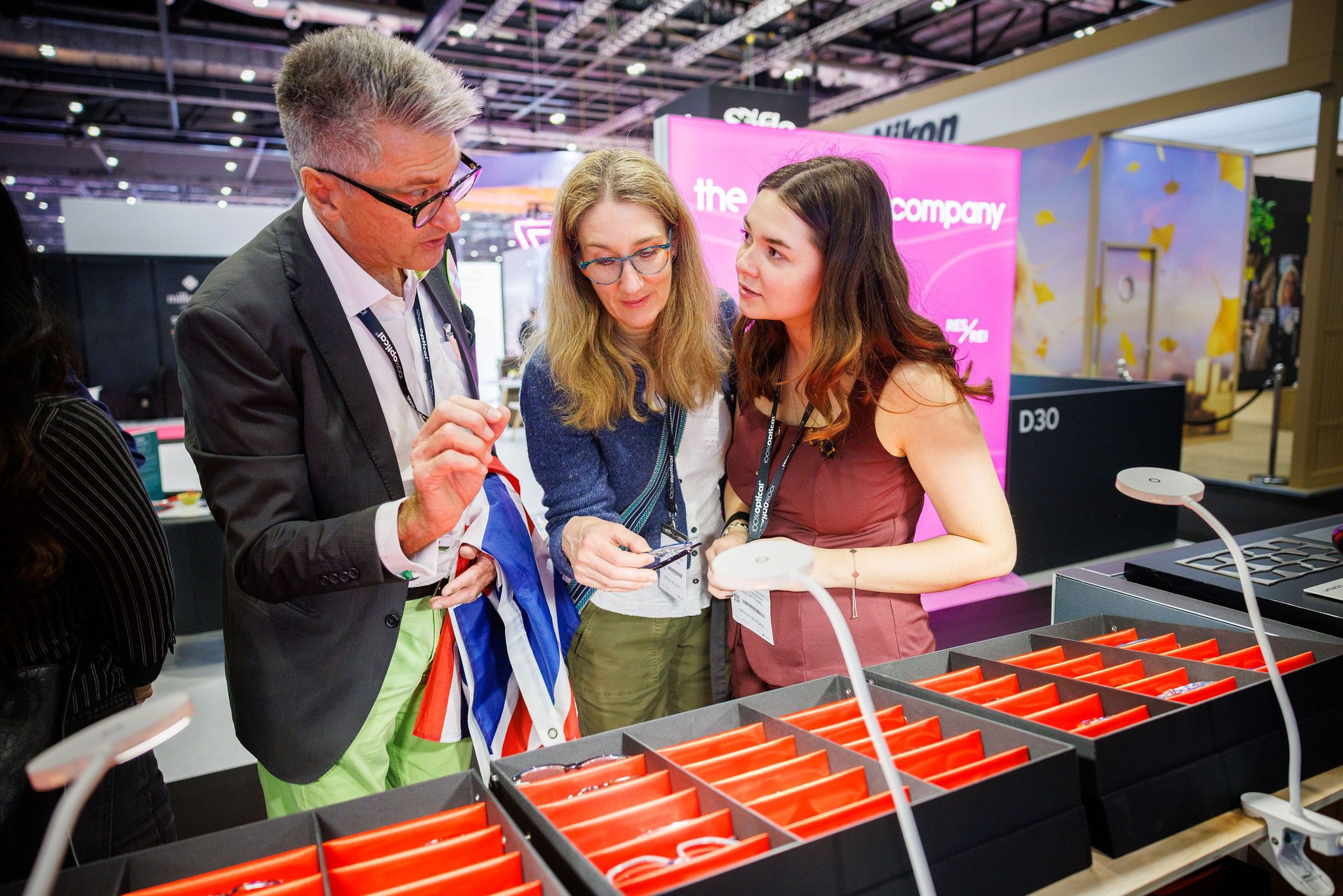A group of people looking at frames at 100% Optical.