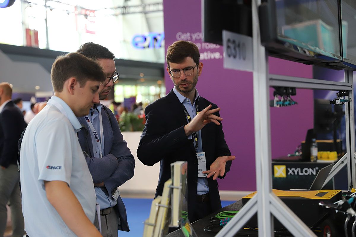 Photo shows visitors and exhibitors networking at ADAS Expo in Stuttgart, Germany