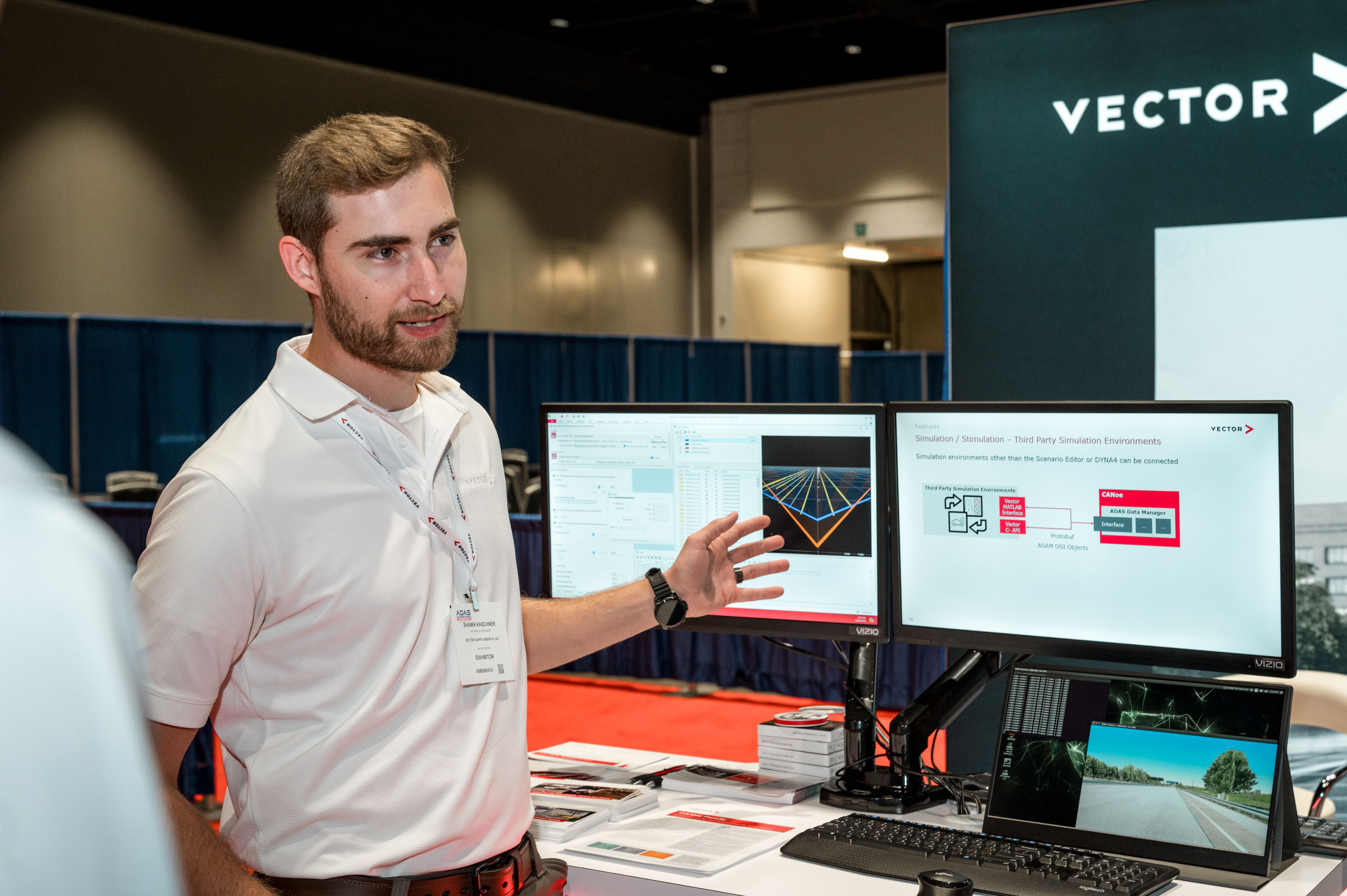 Photo shows an exhibitor explaining the software being showcased