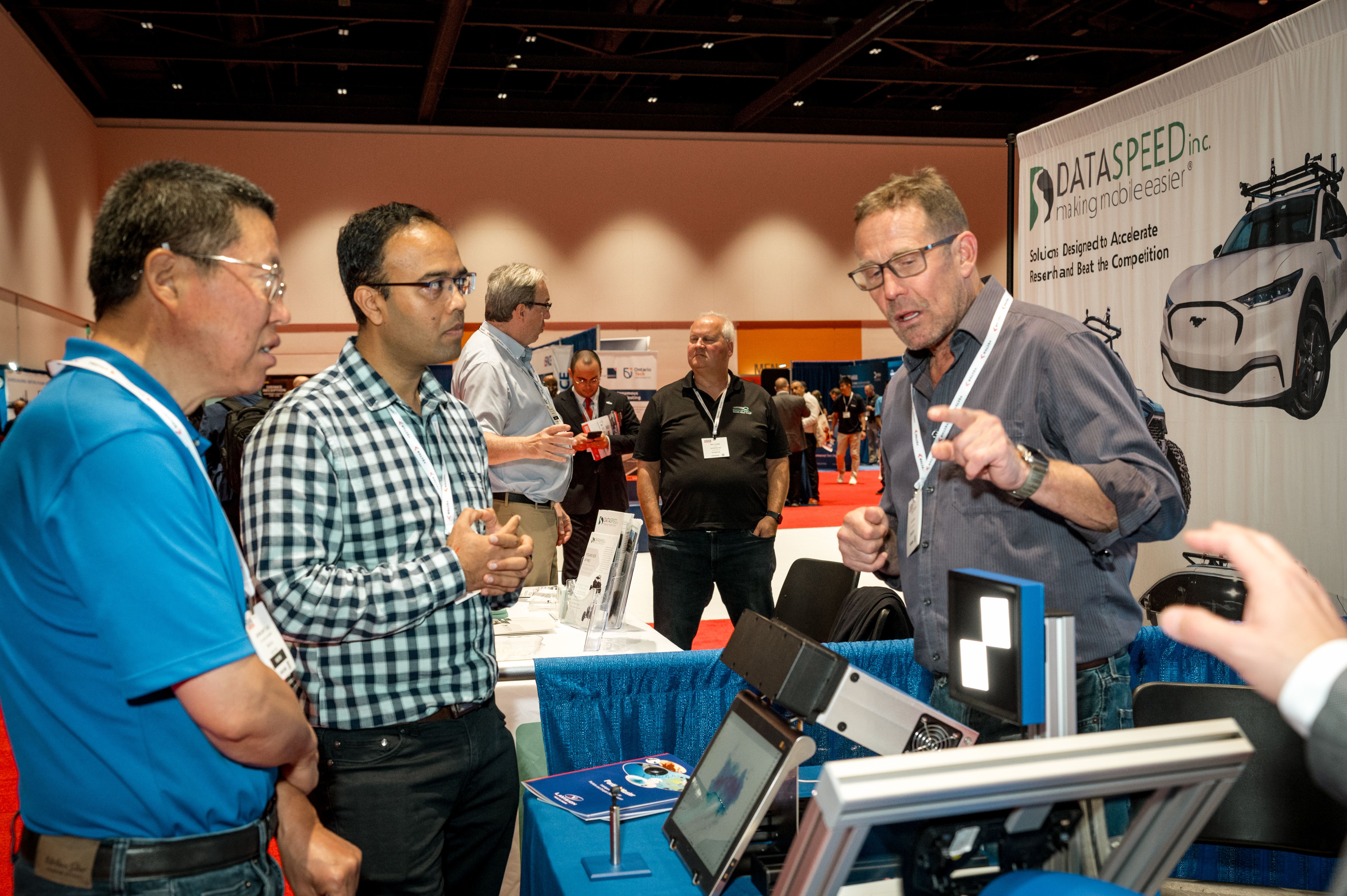 Exhibitors on stand with attendees