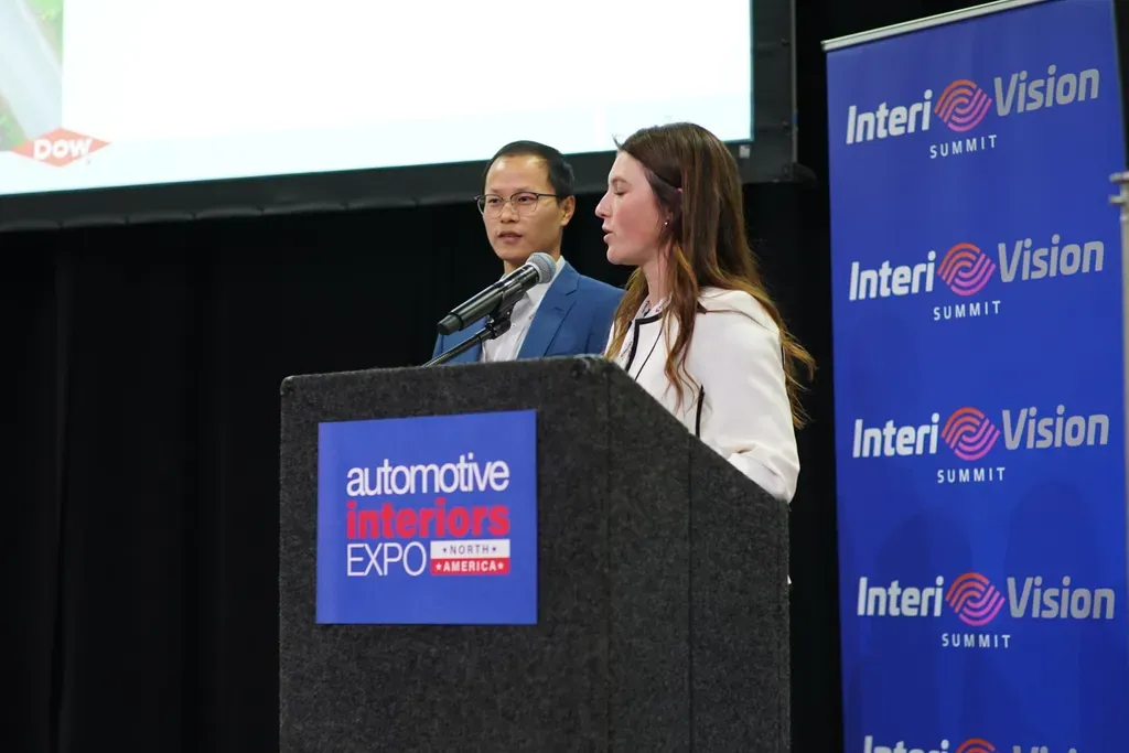 Photo shows two speakers on stage at the Intervision Summit
