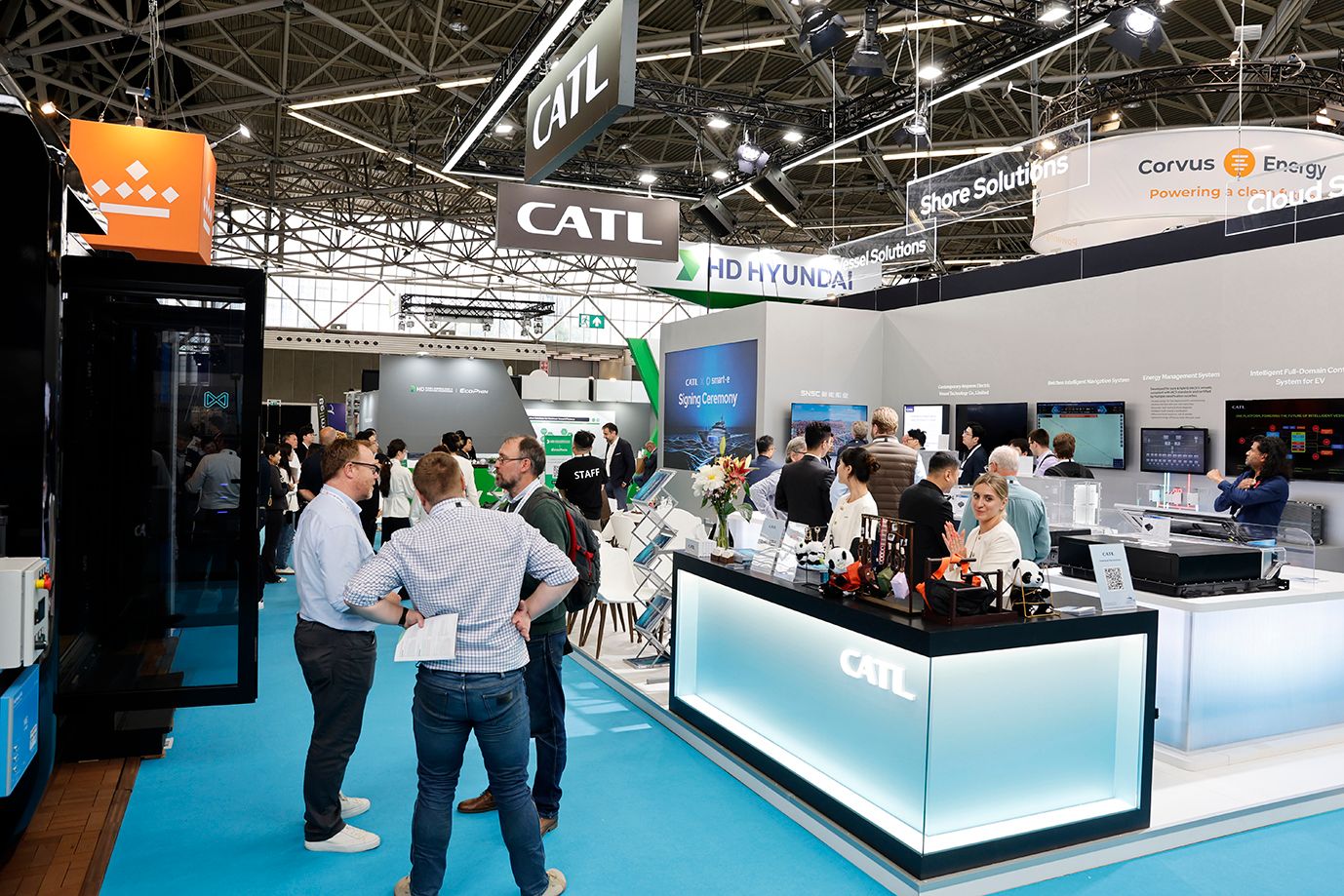 Photo shows exhibitor and visitors on stand at Advanced Maritime Technology Expo