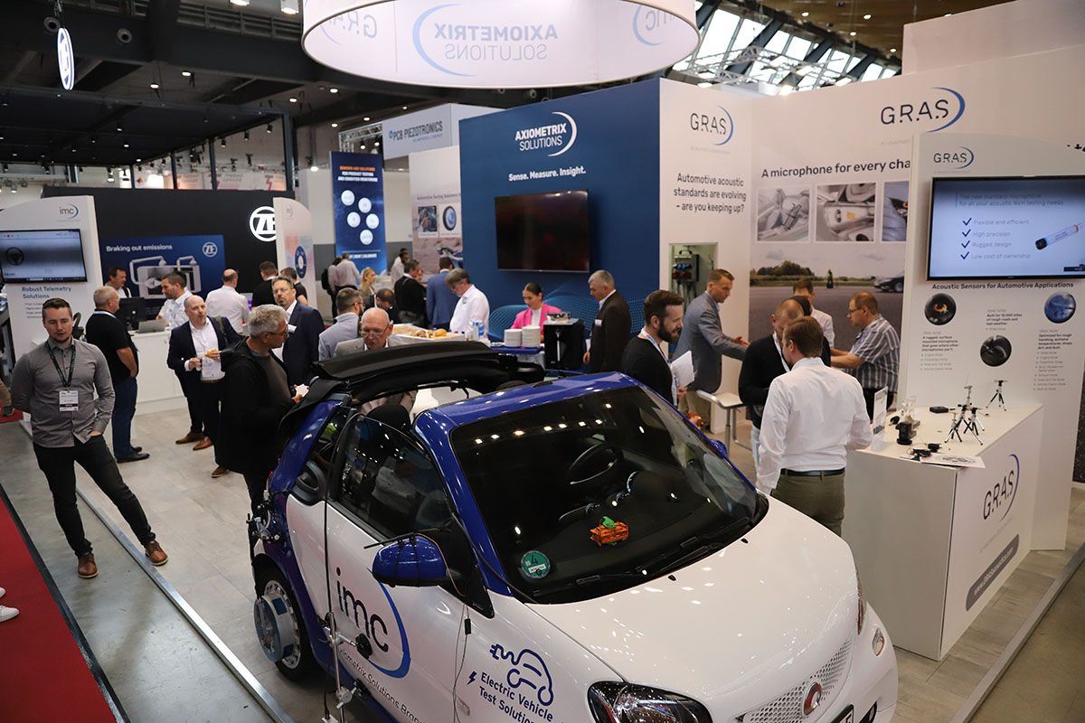 Image shows a busy booth at Automotive Testing Expo in Stuttgart, Germany