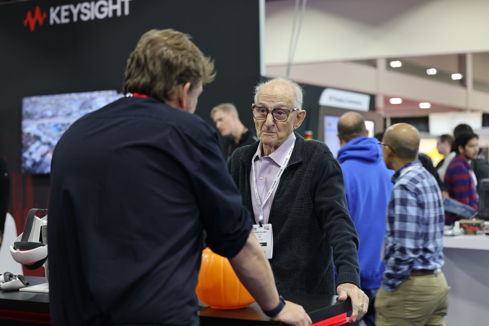 Photo shows visitor and exhibitor at Automotive Testing NA