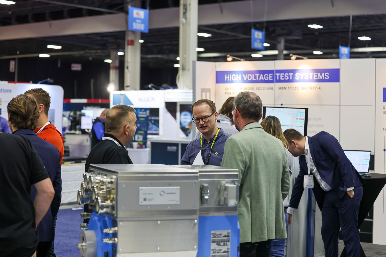 Photo shows an exhibitor networking with visitors at Automotive Testing Expo