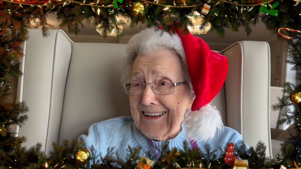 Elderly lady with a christmas hat on 