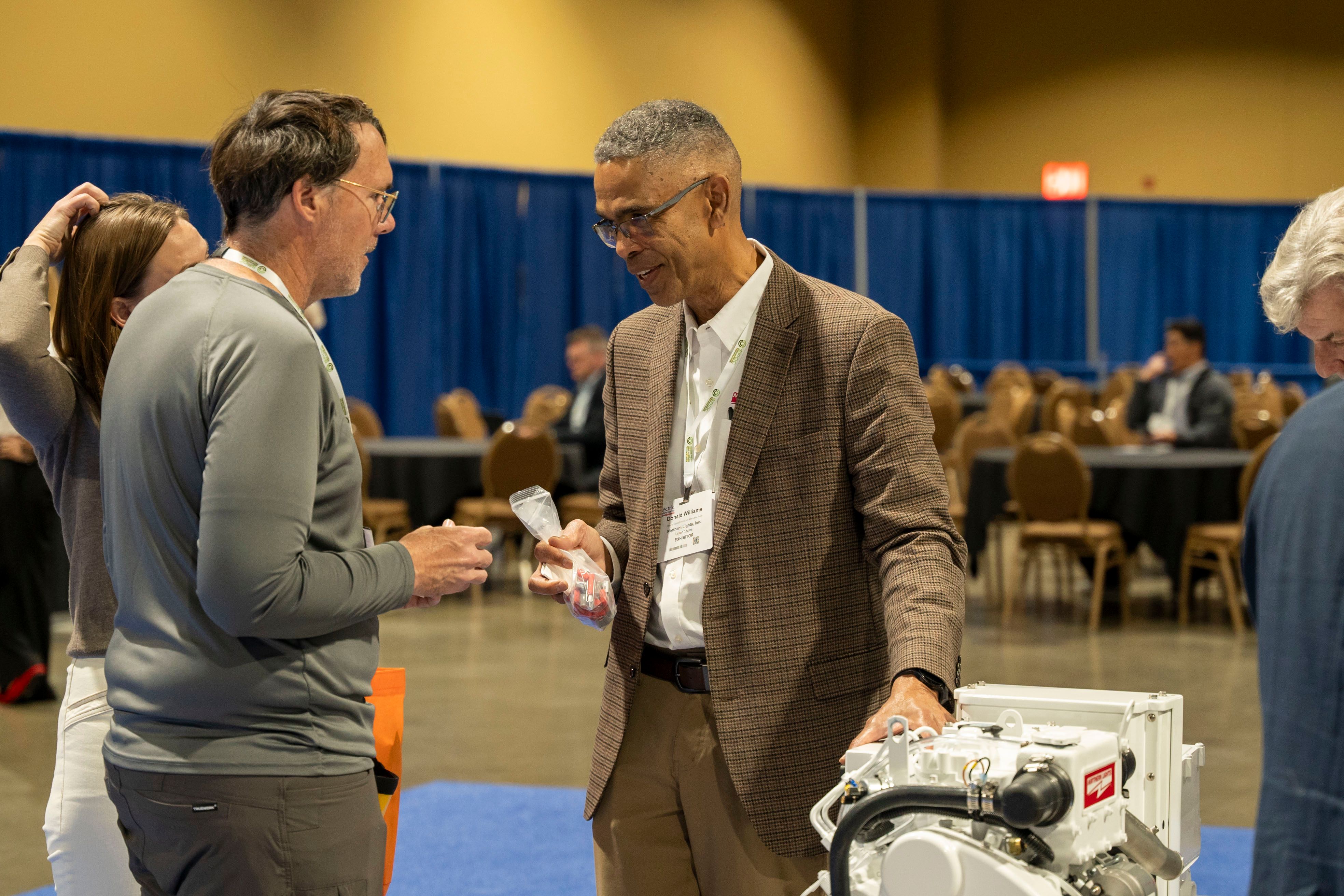 Photo shows  group of Electric & Hybrid Marine Expo attendees networking