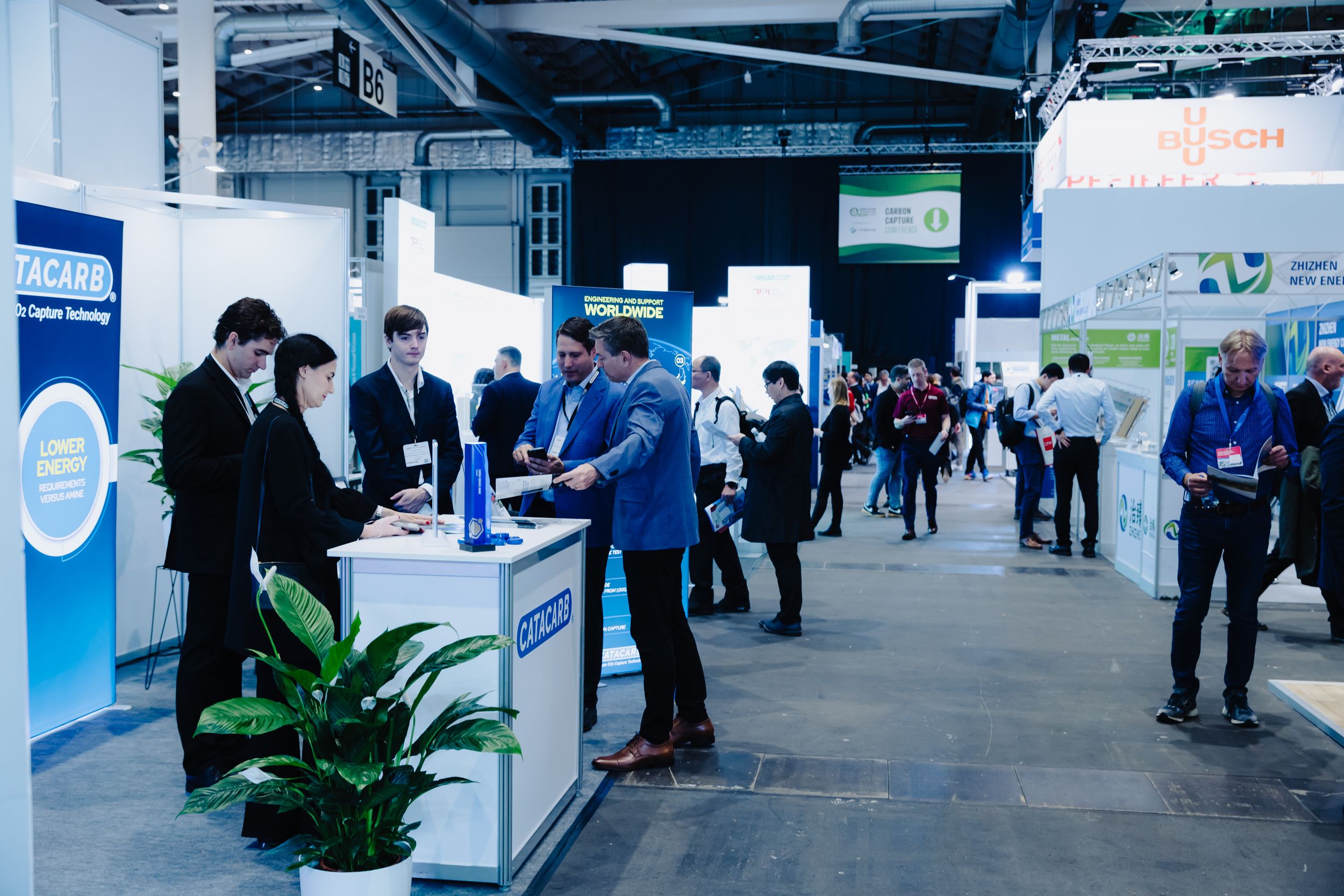 A model plane in the middle of a busy expo floor related image